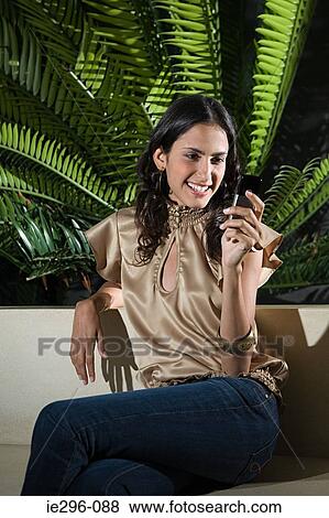Young woman with cellphone View Large Photo Image Stock Photo - Young woman with cellphone. Fotosearch