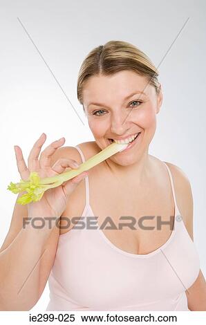 A woman eating celery View Large Photo Image Stock Photography - A woman eating celery. Fotosearch