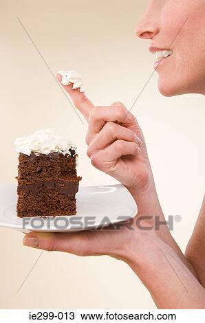 A woman holding a chocolate cake View Large Photo Image Stock Image - A woman holding a chocolate cake. Fotosearch