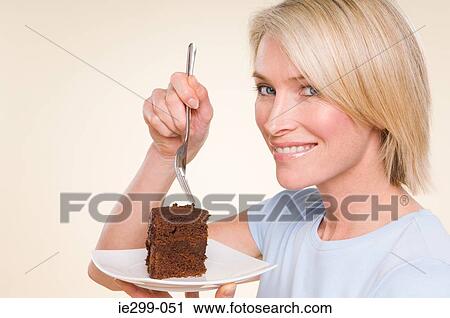 Stock Image - A woman holding a chocolate cake. Fotosearch