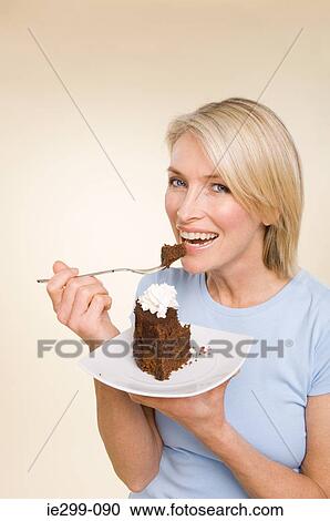 Stock Image - A woman holding a chocolate cake. Fotosearch