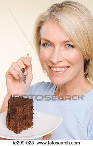 A woman holding a chocolate cake View Large Photo Image Stock Photo - A woman holding a chocolate cake. Fotosearch