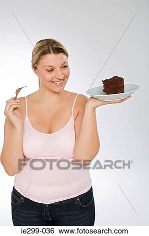 A woman holding a chocolate cake View Large Photo Image Stock Photograph - A woman holding a chocolate cake. Fotosearch