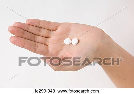 A woman holding diet pills View Large Photo Image Stock Photo - A woman holding diet pills. Fotosearch