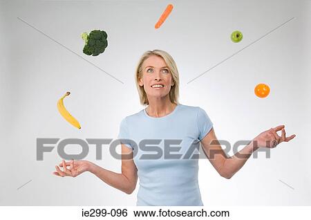 A woman juggling fruit and vegetables View Large Photo Image Stock Photograph - A woman juggling fruit and vegetables. Fotosearch