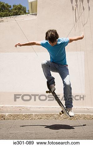 A teenage boy doing jumps with a skateboard View Large Photo Image Stock Photo - A teenage boy doing jumps with a skateboard. Fotosearch