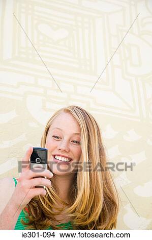 A teenage girl using a cell phone View Large Photo Image Picture - A teenage girl using a cell phone. Fotosearch