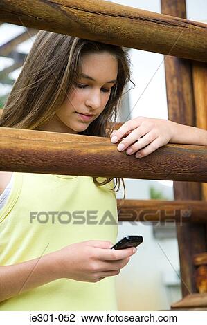 A teenage girl using a cell phone View Large Photo Image Stock Image - A teenage girl using a cell phone. Fotosearch