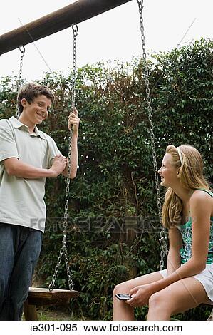 Teenage boy and girl talking View Large Photo Image Stock Photography - Teenage boy and girl talking. Fotosearch
