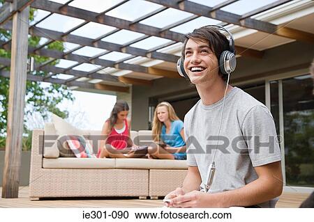 Stock Image - Teenage boy listening to music. Fotosearch