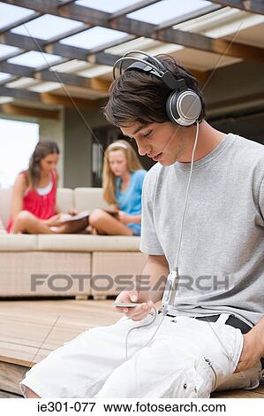 Stock Photo - Teenage boy listening to music. Fotosearch
