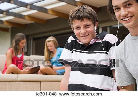 Teenage boys listening to music View Large Photo Image Stock Photo - Teenage boys listening to music. Fotosearch