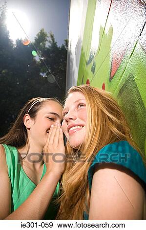 Teenage girls gossiping View Large Photo Image Stock Photo - Teenage girls gossiping. Fotosearch