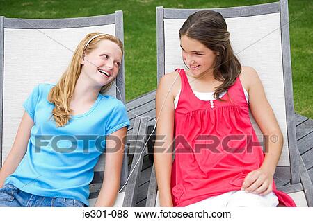 Teenage girls listening to music View Large Photo Image Stock Photo - Teenage girls listening to music. Fotosearch