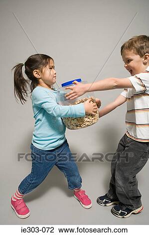 A boy and girl fighting over a jar of biscuits View Large Photo Image Stock Image - A boy and girl fighting over a jar of biscuits. Fotosearch