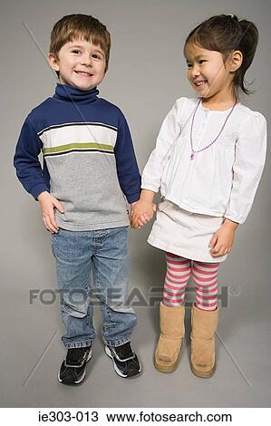 A boy and girl holding hands View Large Photo Image Stock Image - A boy and girl holding hands. Fotosearch