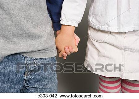 A boy and girl holding hands View Large Photo Image Stock Image - A boy and girl holding hands. Fotosearch