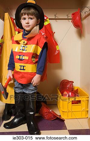 A boy pretending to be a firefighter View Large Photo Image Stock Photography - A boy pretending to be a firefighter. Fotosearch