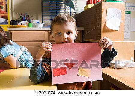 A boy showing a pencil drawing View Large Photo Image Picture - A boy showing a pencil drawing. Fotosearch