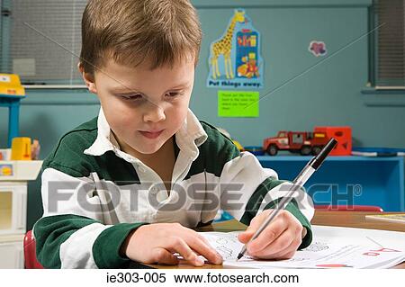 Stock Photography - A boy writing. Fotosearch