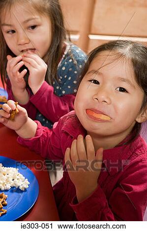 Stock Image - A girl eating an apple. Fotosearch