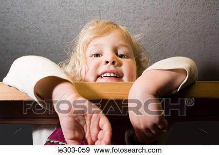 Stock Photo - A girl leaning on a bar. Fotosearch