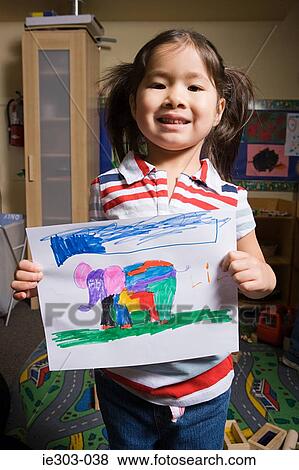 A girl showing a pencil drawing of an elephant View Large Photo Image Stock Photo - A girl showing a pencil drawing of an elephant. Fotosearch
