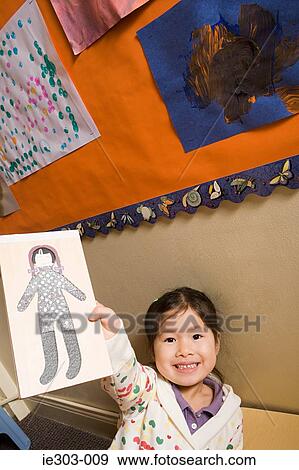 Stock Photo - A girl showing a pencil drawing. Fotosearch