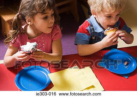 Children eating cakes View Large Photo Image Stock Photograph - Children eating cakes. Fotosearch