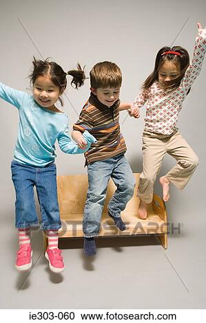 Children jumping off a bench View Large Photo Image Stock Image - Children jumping off a bench. Fotosearch