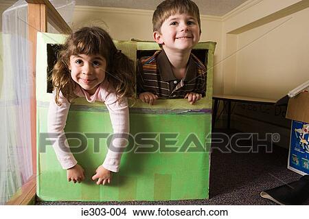 Picture - Children playing in a box. Fotosearch
