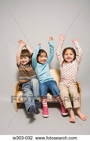 Children with their arms raised View Large Photo Image Stock Image - Children with their arms raised. Fotosearch