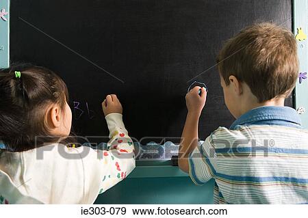 Children writing on a blackboard View Large Photo Image Stock Photo - Children writing on a blackboard. Fotosearch