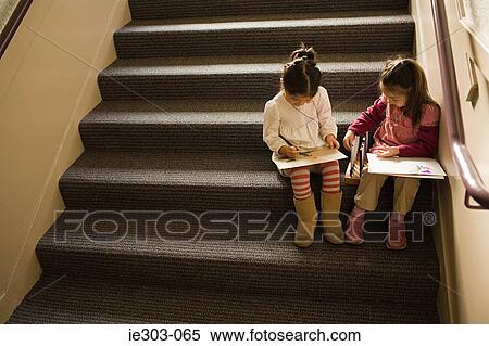 Girls sat on a step drawing View Large Photo Image Stock Photography - Girls sat on a step drawing. Fotosearch