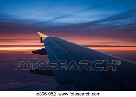 Airplane wing at sunset View Large Photo Image Stock Image - Airplane wing at sunset. Fotosearch