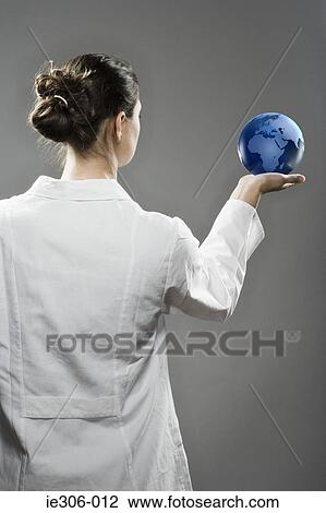 Female scientist holding a globe View Large Photo Image Stock Image - Female scientist holding a globe. Fotosearch