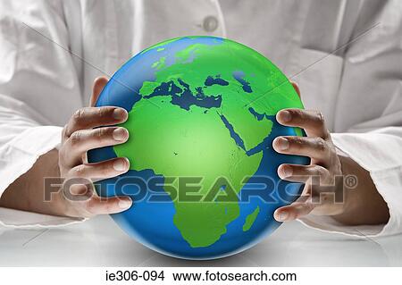Scientist holding a globe View Large Photo Image Picture - Scientist holding a globe. Fotosearch