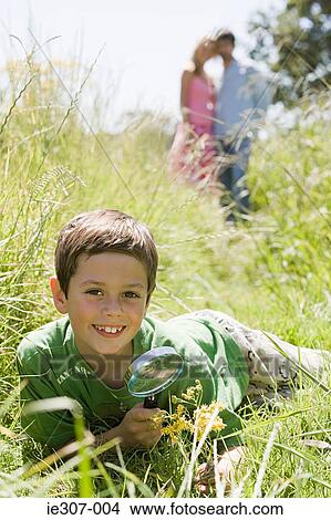 A boy holding a magnifying glass View Large Photo Image Picture - A boy holding a magnifying glass. Fotosearch