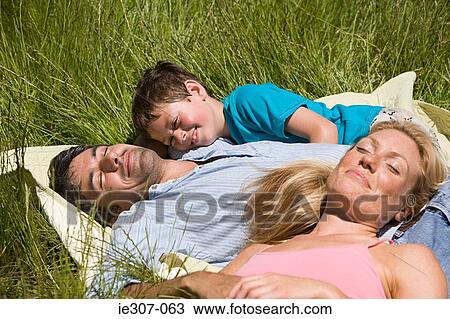 Stock Image - A family sleeping in a field. Fotosearch