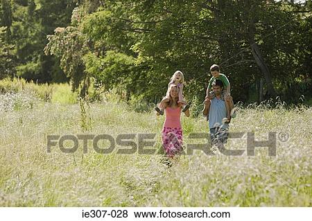 Stock Photo - A family walking through a field. Fotosearch