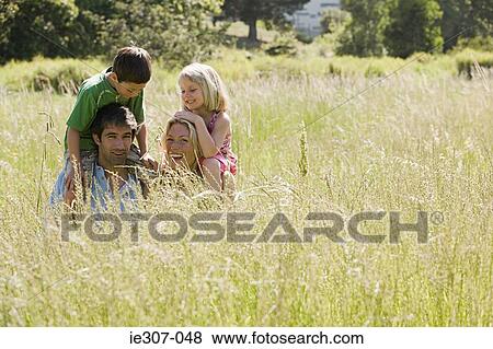 Parents shoulder carrying their children View Large Photo Image Stock Photo - Parents shoulder carrying their children. Fotosearch