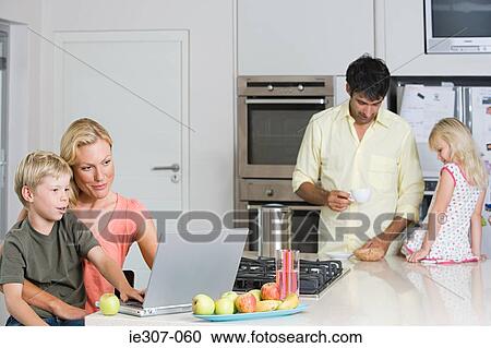 Parents with their children in the kitchen View Large Photo Image Stock Image - Parents with their children in the kitchen. Fotosearch