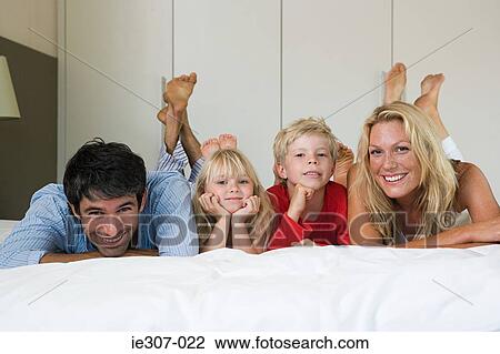 Portrait of a family in bed View Large Photo Image Stock Image - Portrait of a family in bed. Fotosearch