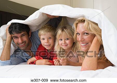 Portrait of a family in bed View Large Photo Image Stock Photo - Portrait of a family in bed. Fotosearch