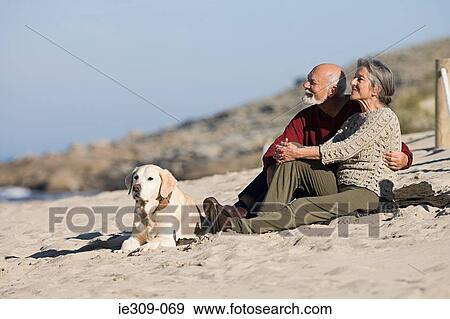 Senior couple relaxing on a beach View Large Photo Image Stock Photo - Senior couple relaxing on a beach. Fotosearch