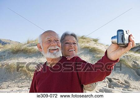 Senior couple taking a self portrait View Large Photo Image Stock Image - Senior couple taking a self portrait. Fotosearch
