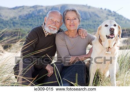 Senior couple with a pet dog View Large Photo Image Stock Photography - Senior couple with a pet dog. Fotosearch