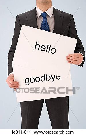 Businessman holding greeting signs View Large Photo Image Stock Image - Businessman holding greeting signs. Fotosearch