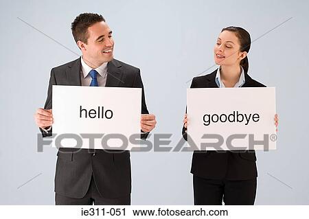 Colleagues holding signs View Large Photo Image Stock Image - Colleagues holding signs. Fotosearch