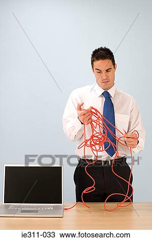 Confused office worker with cable View Large Photo Image Stock Image - Confused office worker with cable. Fotosearch
